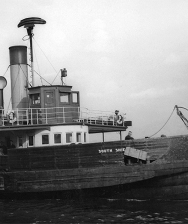 A black and white photos of a historical ferry boat
