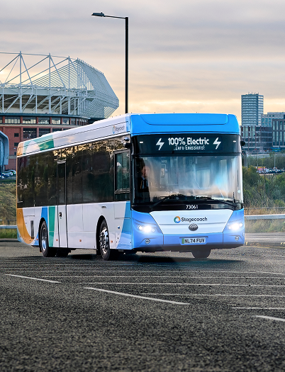A bus driving down a road