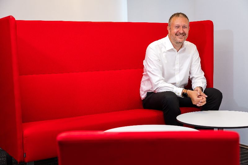 Man on red couch