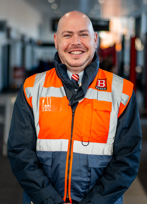 A Nexus employee in bus station uniform