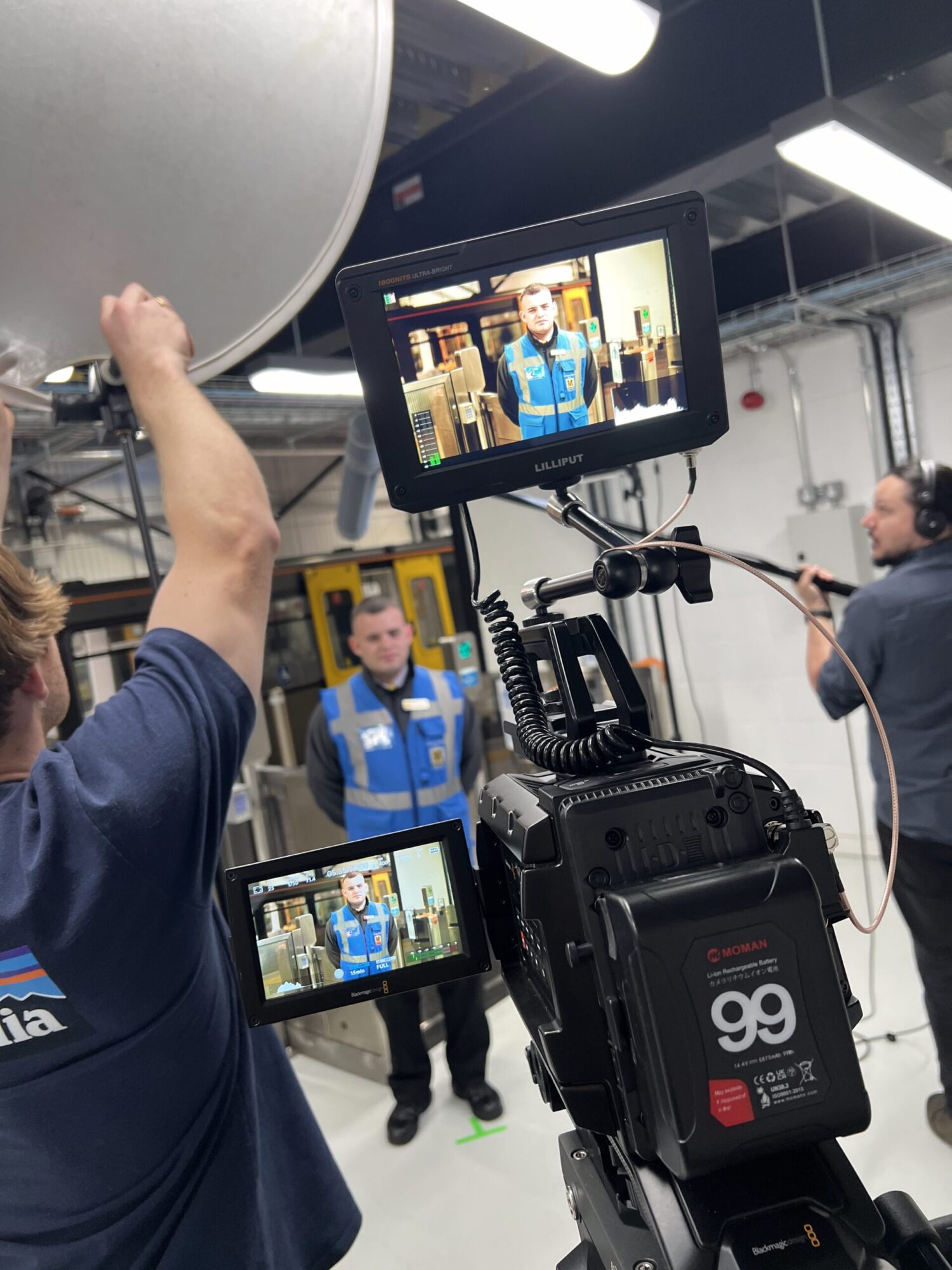 A film crew filming a Metro employee
