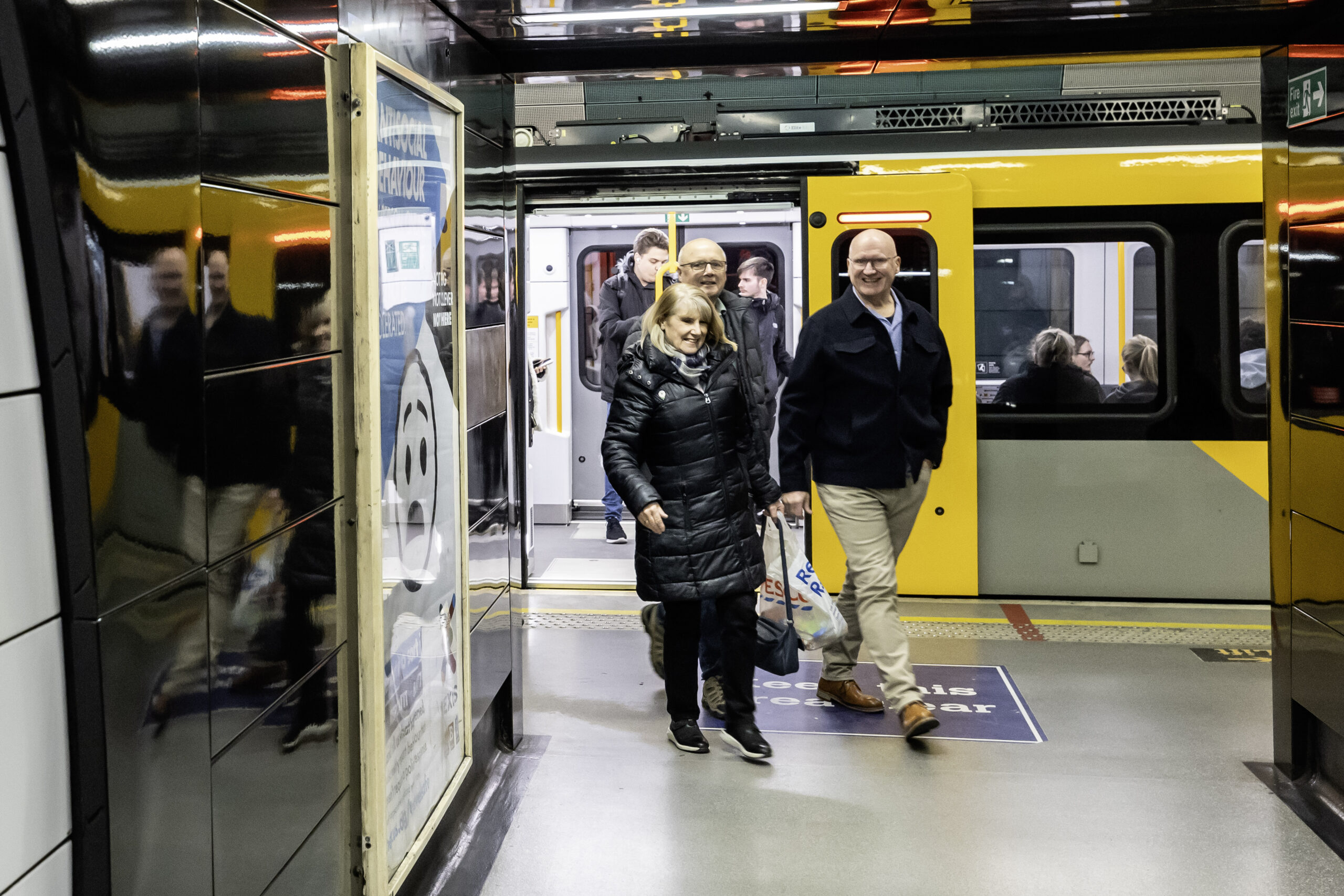 Customers getting off a Metro train