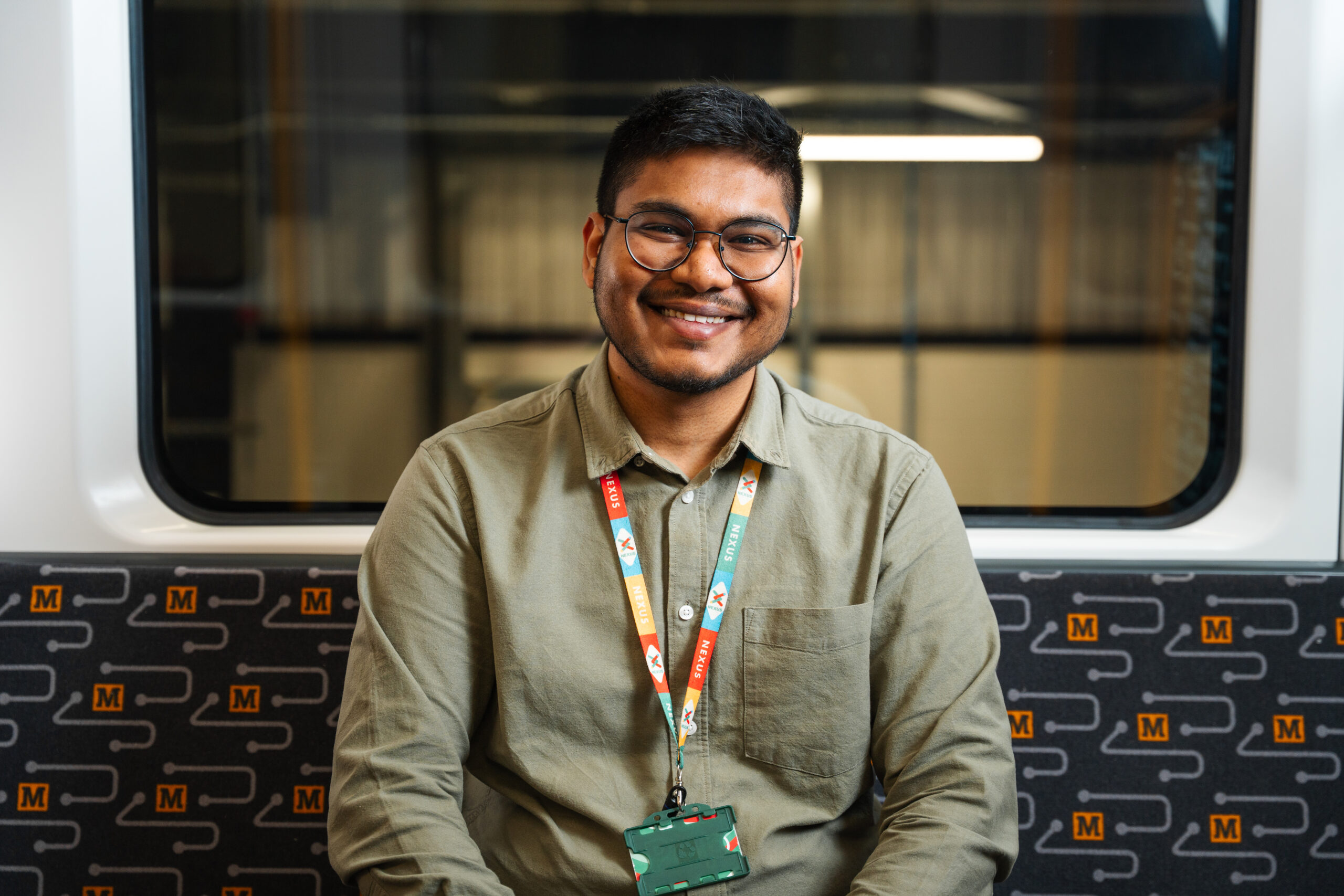 A man sitting on a Metro train