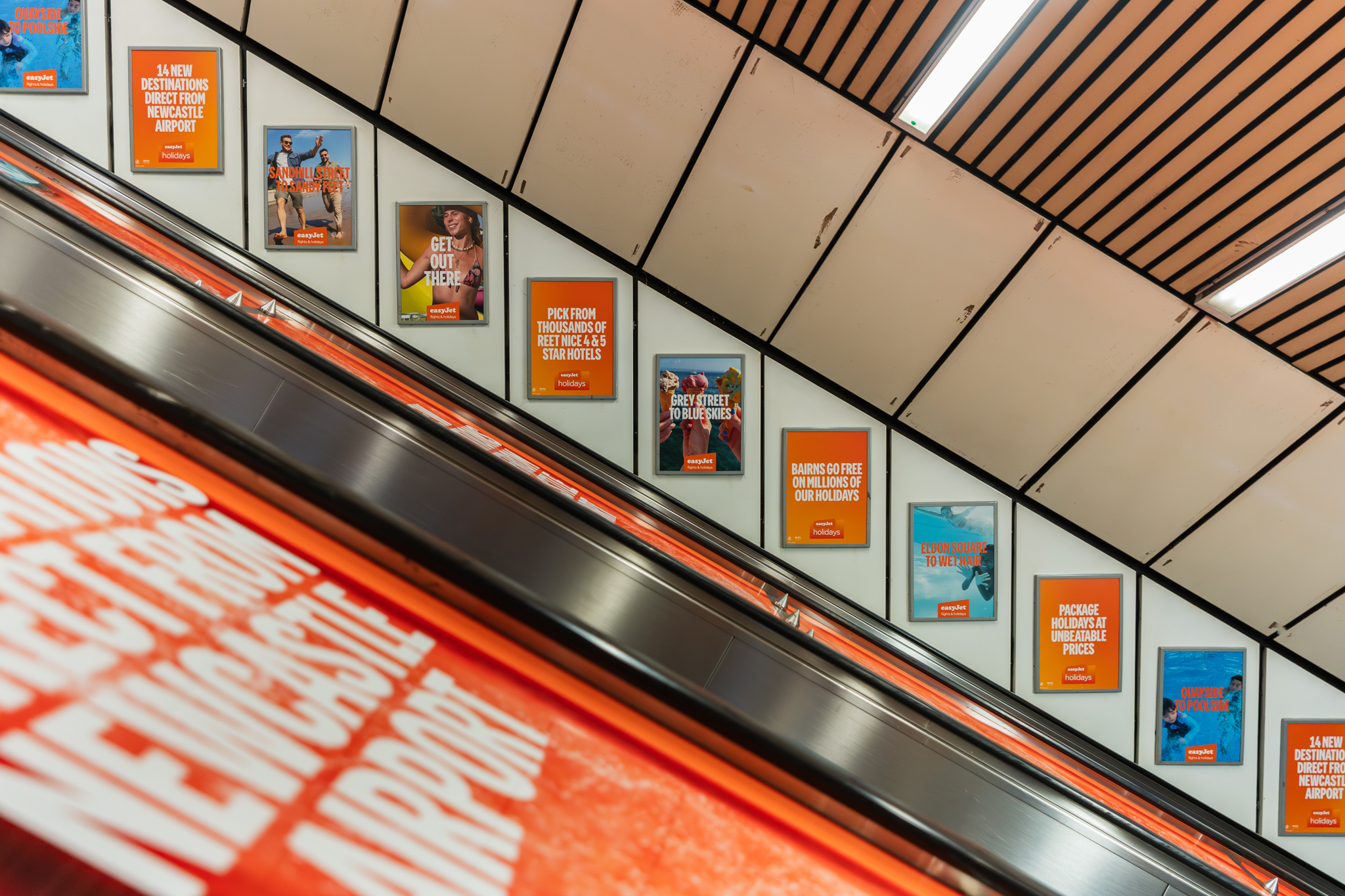 An image of advertising panels next to an escalator