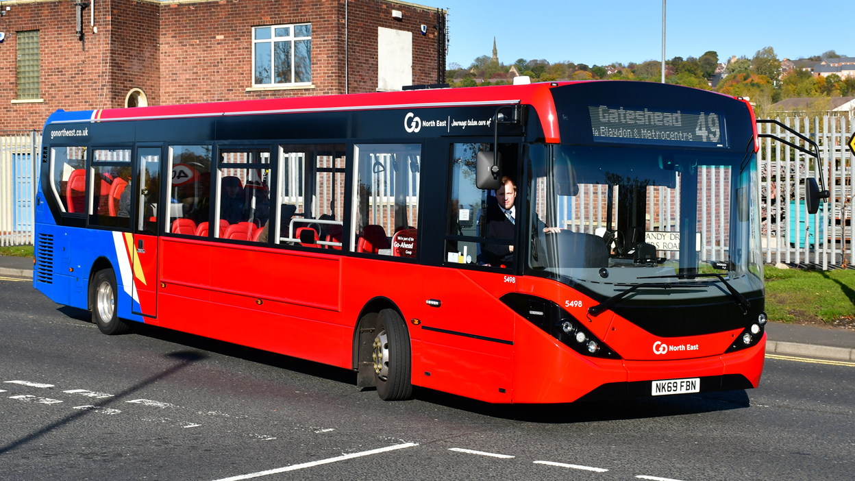 An image of a red single decker bus